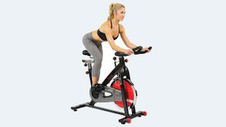 Woman riding the Sunny Health & Fitness Indoor Cycle Bike